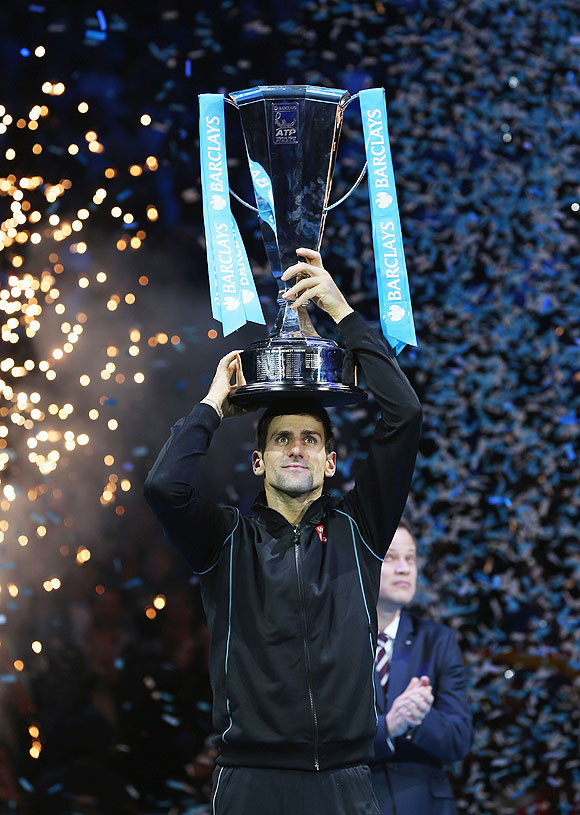 Novak Djokovic of Serbia lifts the trophy after beating Rafael Nadal of Spain to win the final of the ATP World Tour Finals at O2 Arena in London on Monday
