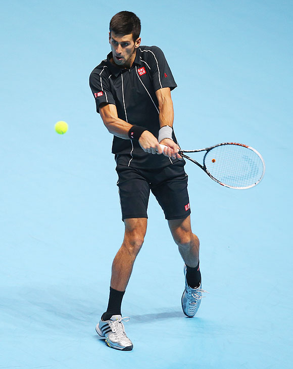 Novak Djokovic of Serbia hits a backhand in his men's singles final against Rafael Nadal of Spain at the ATP World Tour Finals at O2 Arena in London on Monday