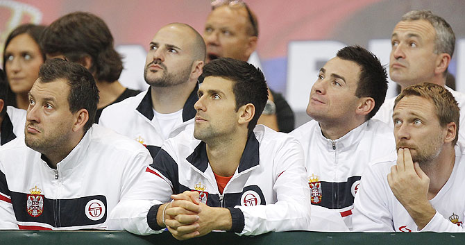 Novak Djokovic (centre) watches the men's singles match between Dusan Lajovic of Serbia and Radek Stepanek of Czech Republic on day three of the Davis Cup World Group Final between Serbia and Czech Republic at Kombank Arena in Belgrade, Serbia, on Sunday