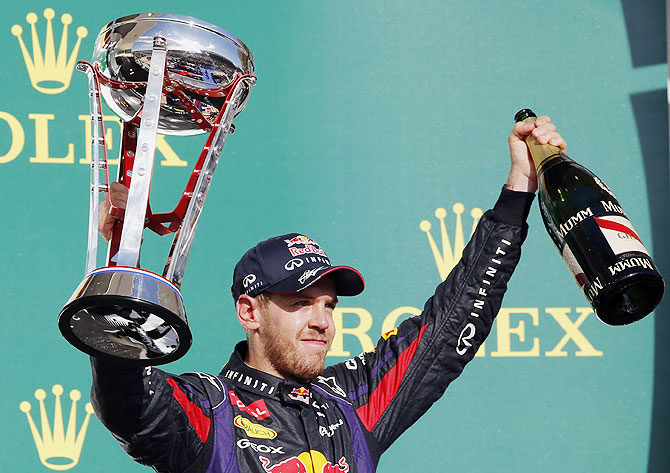 Red Bull Formula One driver Sebastian Vettel of Germany celebrates with his trophy on the podium after winning the Austin F1 Grand Prix at the Circuit of the Americas in Austin, Texas