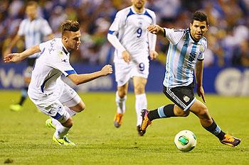 Sergio Aguero of Argentina runs past Ermin Bicakcic (left) of Bosnia-Herzegovina during the international friendly match between Bosnia-Herzegovina and Argentina at Busch Stadium in St. Louis, Missouri on Monday