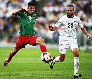 Oribe Peralta of Mexico reaches out for the ball past Andrew Durante of New Zealand during leg 2 of the FIFA World Cup Qualifier at Westpac Stadium in Wellington, on Wednesday