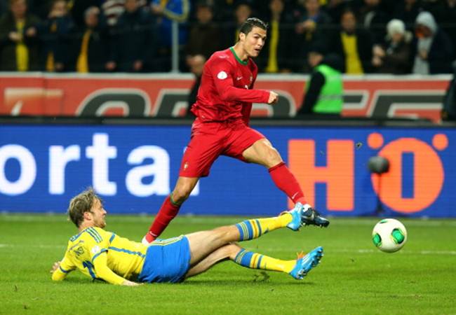 Cristiano Ronaldo scores Portugal's second goal during the FIFA 2014 World Cup Qualifier Play-off second leg match against Sweden at Friends Arena in Stockholm