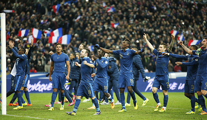 France's players celebrate after winning their 2014 World Cup qualifying second leg playoff match against Ukraine at the Stade de France in Saint-Denis near Paris on Tuesday
