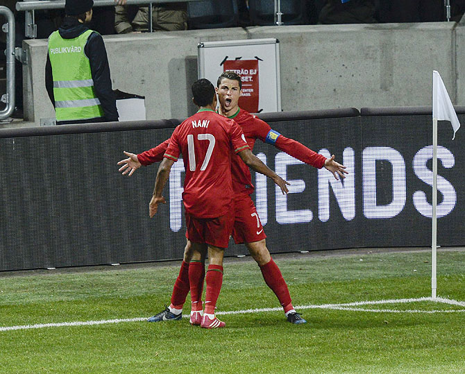 Portugal's Cristiano Ronaldo celebrates his goal with teammate Nani during their second leg of their 2014 World Cup qualifying against Sweden at Friends Arena in Stockholm on Tuesday