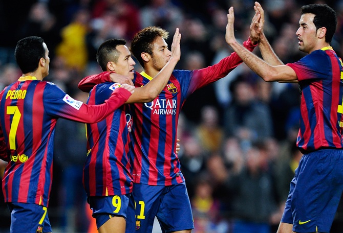 Alexis Sanchez (second left) of FC Barcelona celebrates with his teammates