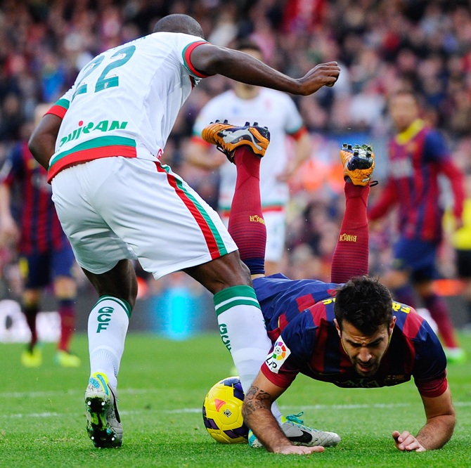 Cesc Fabregas of FC Barcelona is brought down by Foulquier for a penalty of Granada CF