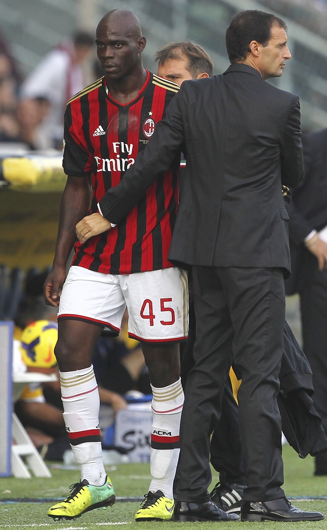 Mario Balotelli (left) of AC Milan is greeted by manager Massimiliano Allegri