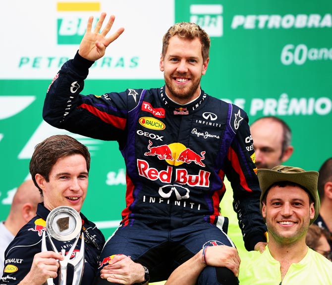 Sebastian Vettel celebrates with Red Bull team after winning the Brazilian Grand Prix