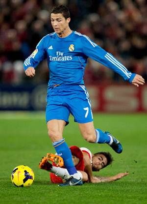 Cristiano Ronaldo of Real Madrid CF competes for the ball with Jesus Saez de la Torre alias Suso of Almeria UD during the La Liga match