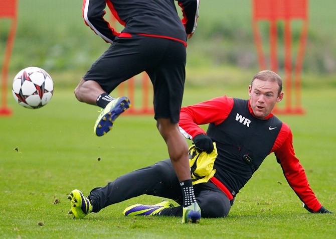 Wayne Rooney (right) of Manchester United in action during a training session