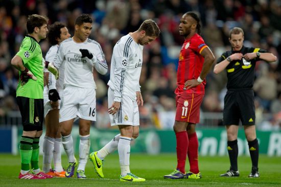 Sergio Ramos of Real Madrid CF leaves the pitch defeated after referee William Collum has shown him the red card 