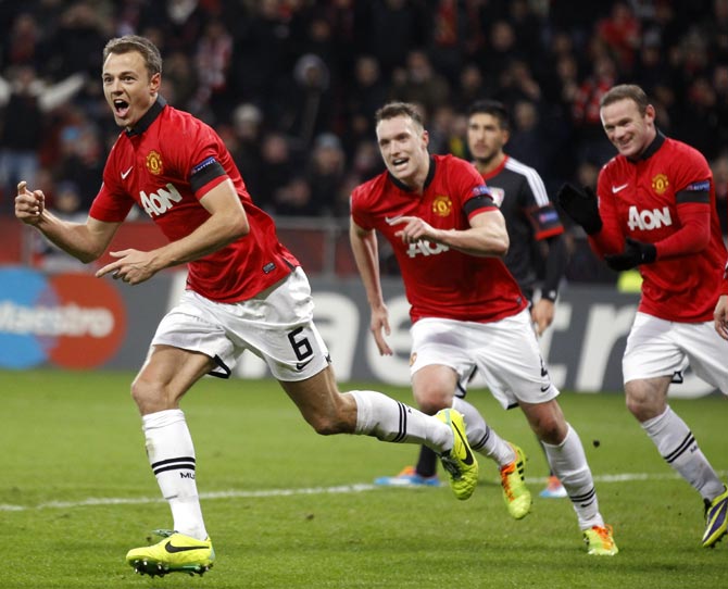 Manchester United's Jonny Evans (left) celebrates after scoring a goal past against Bayer Leverkusen