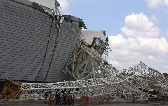 Members of the civil defence arrive to the area where a crane collapsed, on the site of the Arena Sao Paulo stadium