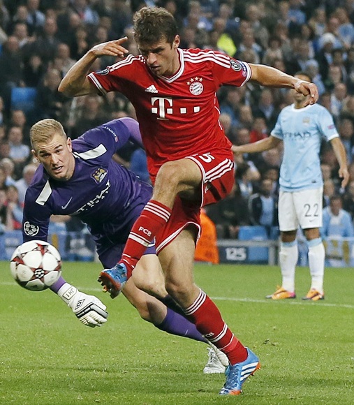 Bayern Munich's Thomas Muller (right) scores during their Champions League match against Manchester City at the Etihad Stadium in Manchester on Wednesday night