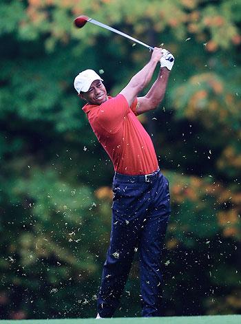 Tiger Woods of the U.S. Team hits his approach shot on the 15th hole during the weather delayed Day Two Foursome Matches at the Muirfield Village Golf Club