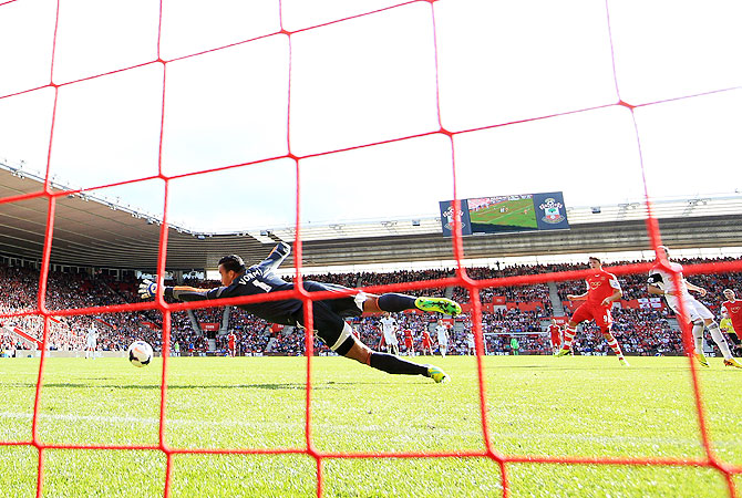 Jay Rodriguez of Southampton (2nd from right) shoots past goalkeeper Michel Vorm of Swansea City to score their second goal during the English Premier League match at St Mary's Stadium in Southampton on Sunday