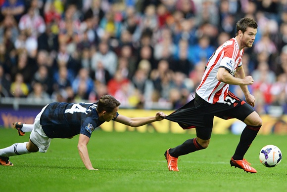 Ondrej Celustka of Sunderland has his shorts pulled by Adnan Januzaj of Manchester United
