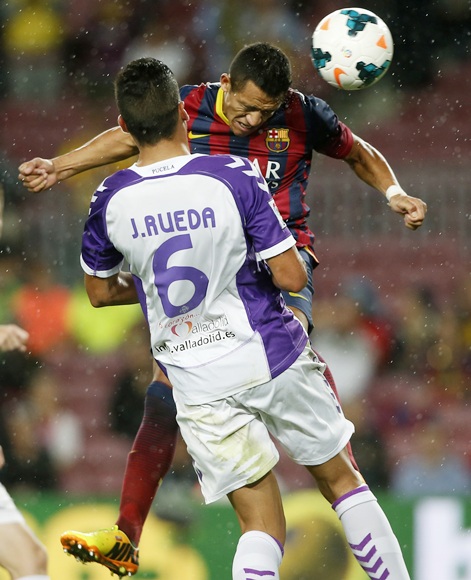 Barcelona's Alexis Sanchez (right) jumps to the head the ball in front of Real Valladolid's Jesus Rueda