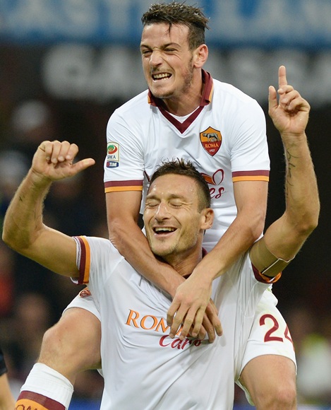 Francesco Totti of AS Roma (centre) celebrates his goal with teammate Alessandro Florenzi