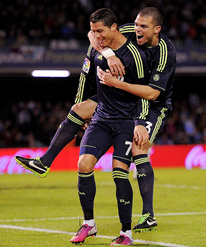 Cristiano Ronaldo (left) of Real Madrid celebrates with teammate Pepe