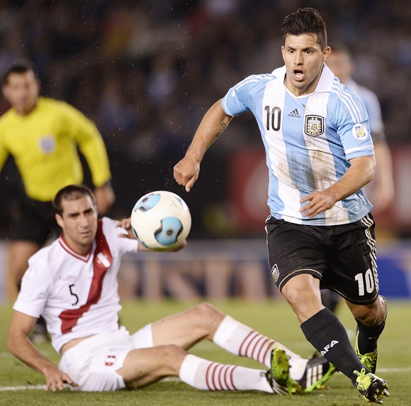 Sergio Aguero (right) of Argentina vies for the ball with Gianmarco Gambetta of Peru