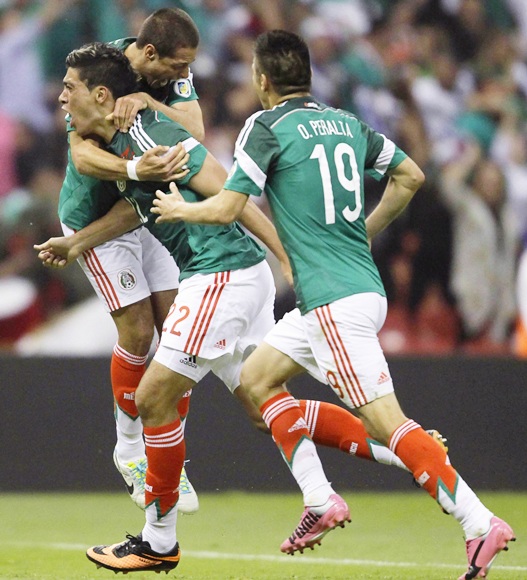 Raul Jimenez (22) of Mexico celebrates with team mates Javier Hernandez (rear) and Oribe Peralta (19)