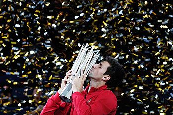 Novak Djokovic of Serbia poses with the winner's trophy after defeating Juan Martin Del Potro of Argentina during day seven of the Shanghai Masters 
