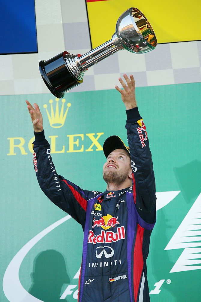 Sebastian Vettel of Germany and Infiniti Red Bull Racing celebrates on the podium after winning the Japanese Formula One Grand Prix at Suzuka Circuit on Sunday