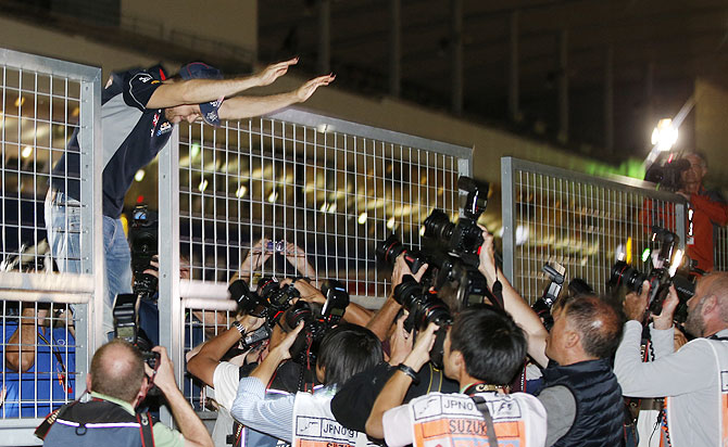 Red Bull Formula One driver Sebastian Vettel of Germany waves to fans after winning the Japanese F1 Grand Prix at the Suzuka circuit on Sunday