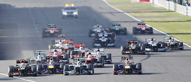 Lotus' Romain Grosjean (left), Red Bull's Mark Webber (right), Mercedes' Lewis Hamilton and Red Bull's Sebastian Vettel fight for the first position during the Japanese F1 Grand Prix at the Suzuka circuit on Sunday