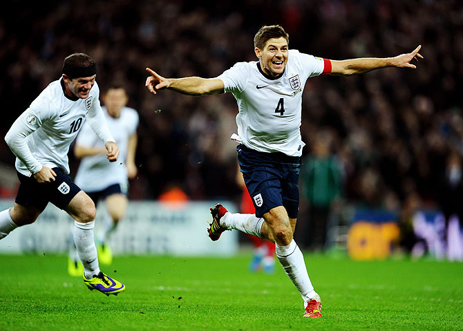 Steven Gerrard of England celebrates as he scores their second goal during the FIFA 2014 World Cup Qualifying Group H match against Poland at Wembley Stadium in London on Tuesday