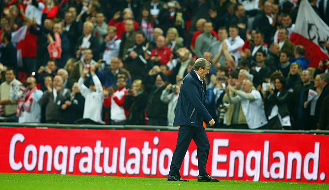 Roy Hodgson walks off the pitch after England beat Poland to qualify for the 2014 World Cup
