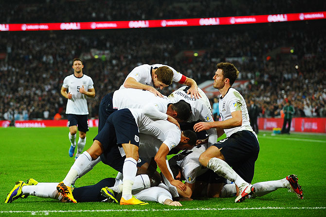 England players celebrate after Wayne Rooney's goal on Tuesday
