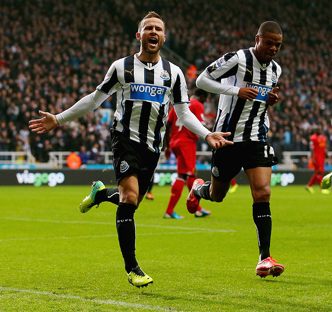 Yohan Cabaye of Newcastle United celebrates their first goal with teammate Loic Remy during the English Premier League match against Liverpool at St James' Park in Newcastle on Saturday