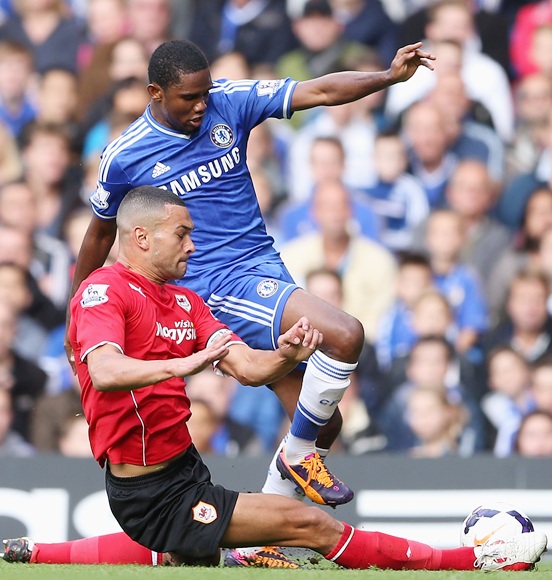 Samuel Eto'o of Chelsea is tackled by Steven Caulker of Cardiff 