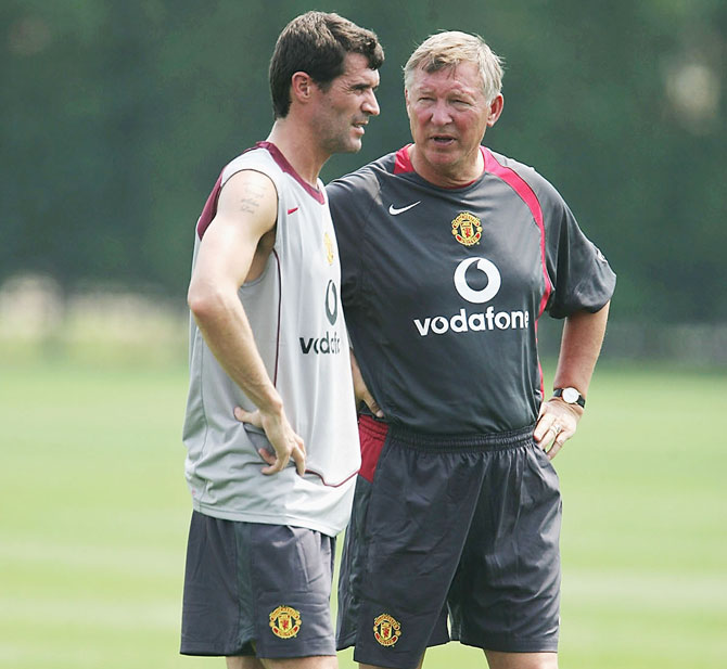 Footballer Roy Keane and Manager Sir Alex Ferguson stand together during a training session
