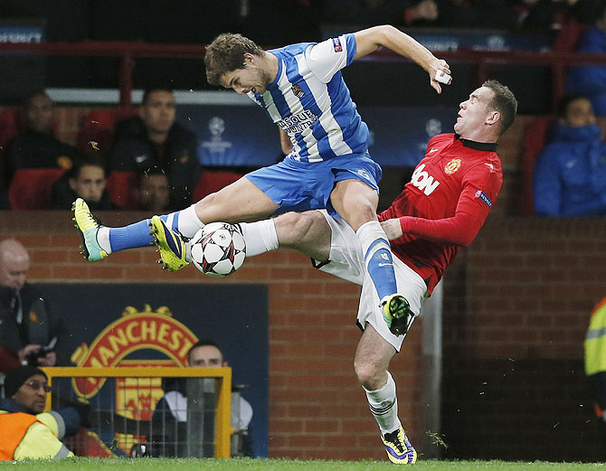 Manchester United's Wayne Rooney (right) challenges Real Sociedad's Inigo Martinez during their Champions League match at Old Trafford on Wednesday
