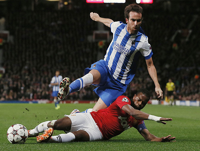 Manchester United's Patrice Evra (right) challenges Real Sociedad's Mikel Gonzalez during their Champions League match at Old Trafford on Wednesday