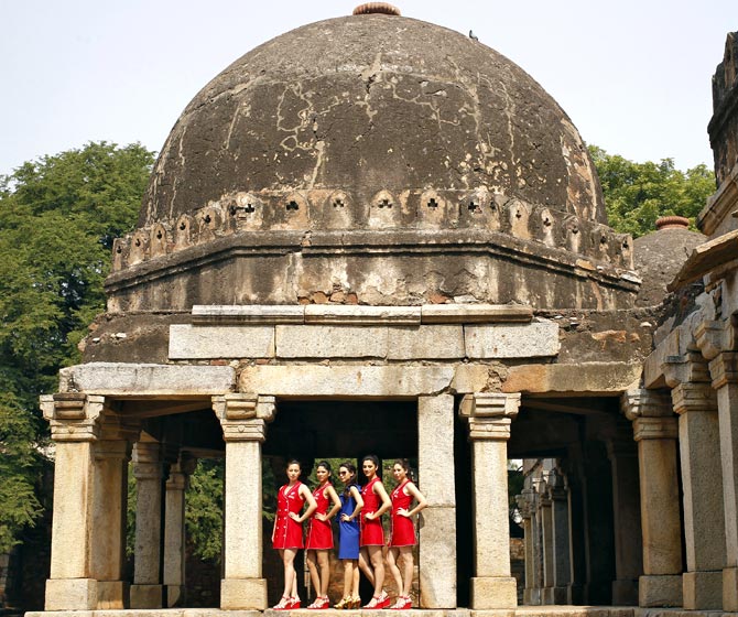 Formula One grid girls pose at the tomb of Firoz Shah in New Delhi