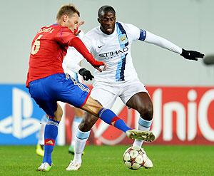 Aleksei Berezutski (L) of PFC CSKA Moscow in action against Yaya Toure of Manchester City FC during the UEFA Champions League Group D match on Wednesday