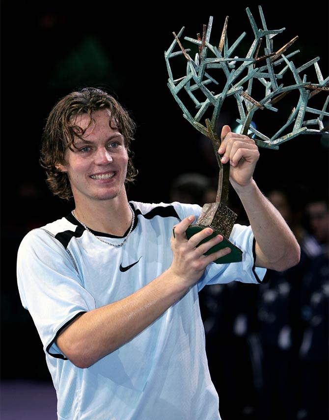 Tomas Berdych of the Czech Republic holds aloft the trophy after his five set victory against Ivan Ljubicic of Croatia in the final