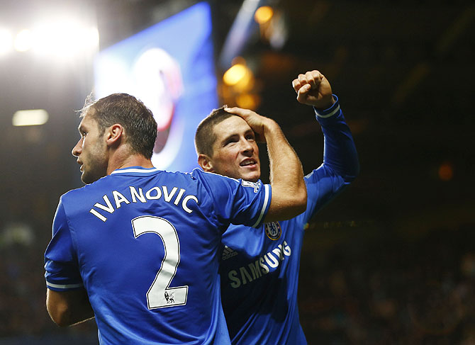 Chelsea's Fernando Torres (rights) celebrates with teammate Branislav Ivanovic after scoring a goal against Manchester City during their English Premier League match at Stamford Bridge in London on Sunday