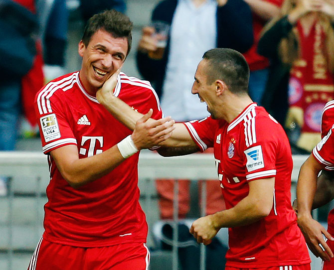 Mario Mandzukic (left) and Franck Ribery of FC Bayern Munich celebrate a goal during their Bundesliga match against Hertha Berlin in Munich on Sunday