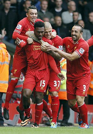 Liverpool players celebrate with Danny Sturridge after a goal against Manchester United on Sunday