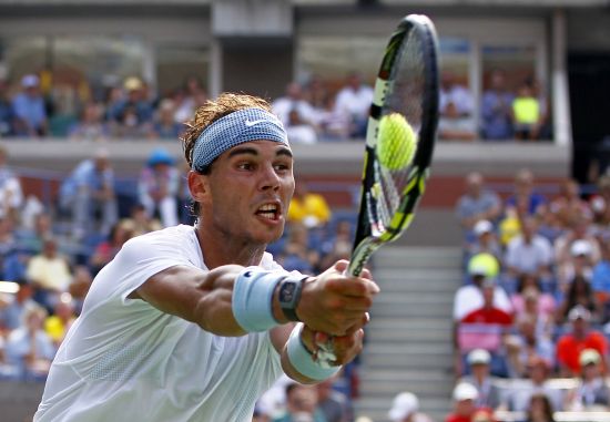 Rafael Nadal of Spain hits a return to Ivan Dodig of Croatia at the U.S. Open 