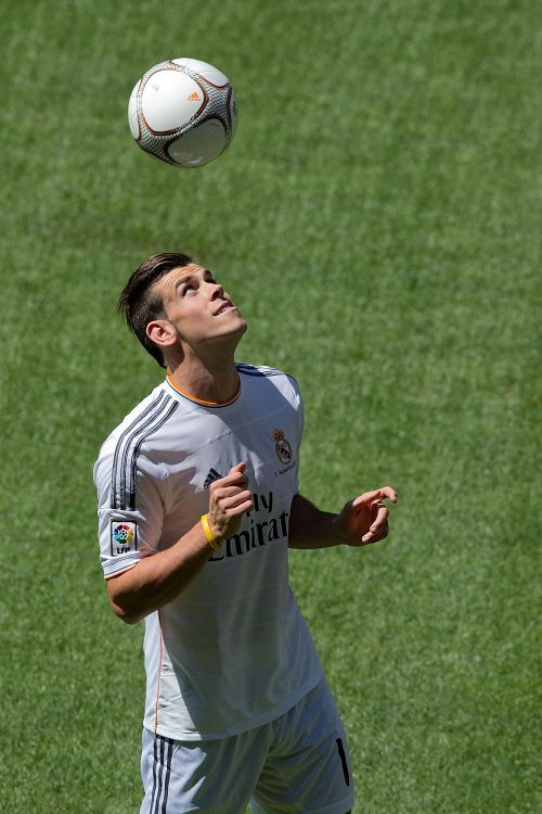 Gareth Bale with his new Real Madrid shirt controls the ball 