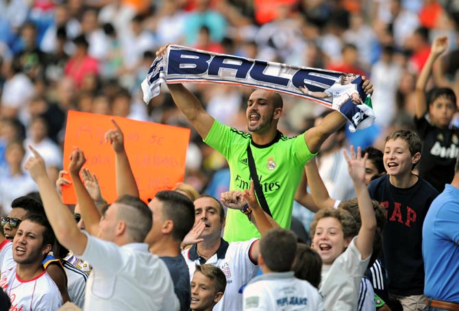 Real Madrid fans cheer during the official unveiling of Gareth Bale at Santiago Bernabeu in Madrid