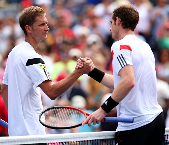 Andy Murray of Great Britain shakes hands at the net with Florian Mayer of Germany