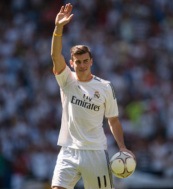 Gareth Bale waves to fans in his new Real Madrid shirt during his official unveiling at estadio Santiago Bernabeu